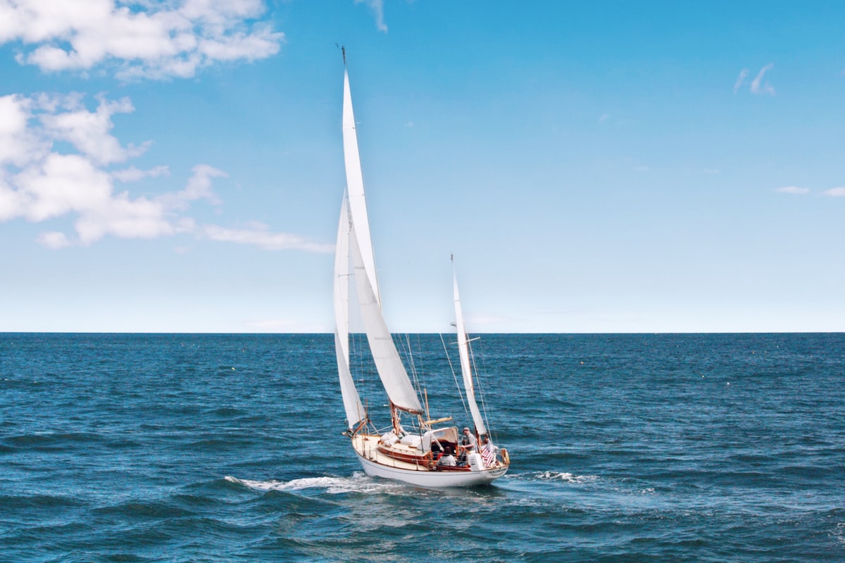 Sailboat under full sail on open blue water off the Florida coast